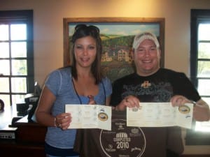 Seth and Amber Harrison of Iowa proudly display their completed Kentucky Bourbon Trail Passports at their last stop, Woodford Reserve Distillery in Versailles, Kentucky