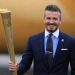 David Beckham holds the London Olympic Flame Torch as it arrives in England
