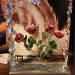 4 frozen roses in a block of ice that appear the same as they did in a vintage Four Roses advertisement that won many awards
