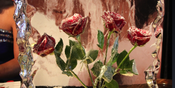 4 frozen roses in a block of ice that appear the same as they did in a vintage Four Roses advertisement that won many awards